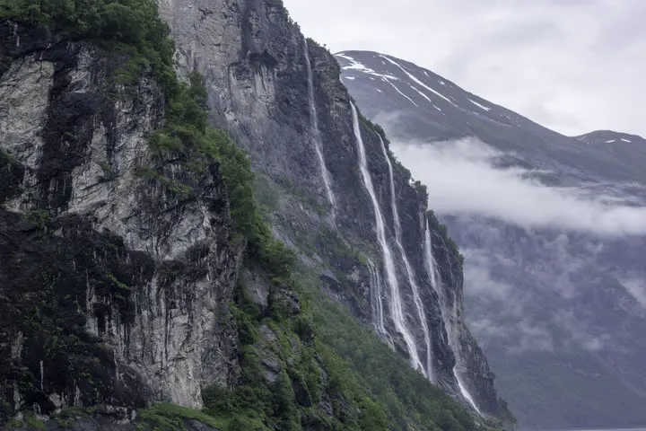 Geirangerfjord waterfalls and steep shoreline, illustrating the value of staying near the fjord